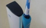 An electric toothbrush standing on its induction charger